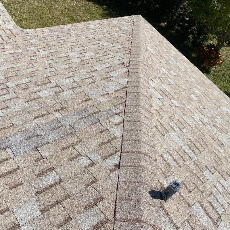 Shingle roof with ridge vent and ventilation pipe