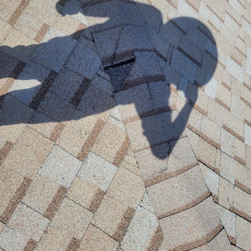 Asphalt shingle roof with shadows during inspection
