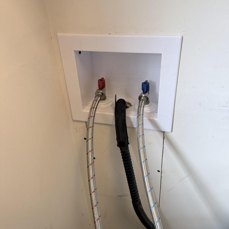Laundry box with supply hoses and drain in wall Laundry box with supply hoses and drain in wall