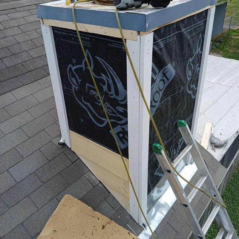 Chimney with new flashing and weather barrier installation