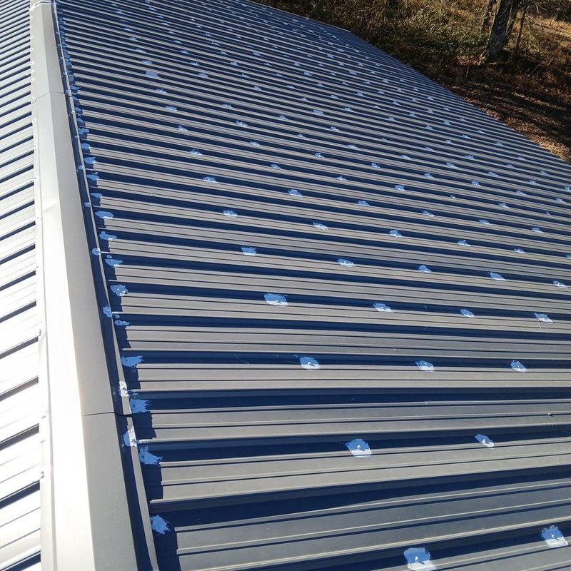 Metal garage roof with sealant on screw heads