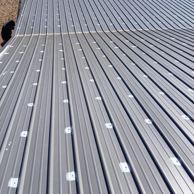 Metal roof screw head sealant on detached garage roof