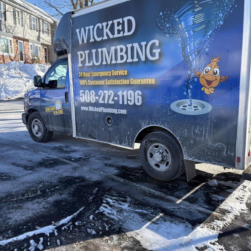 Plumbing service truck with company branding outdoors