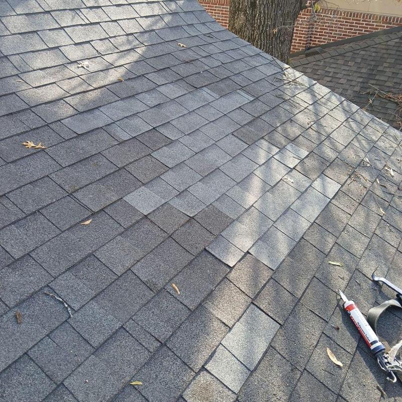 Roof shingles with repair tools and sealant on roof