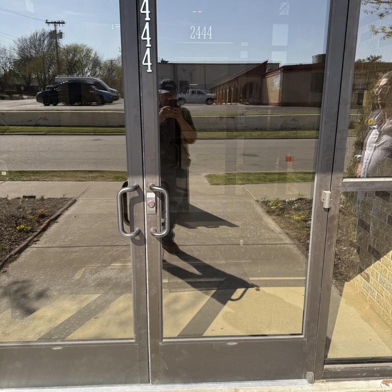 Glass double door entry with metal frame and handles