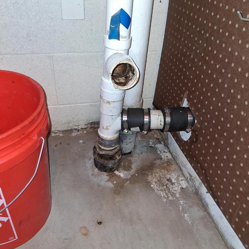 PVC drain pipe with coupling near basement wall