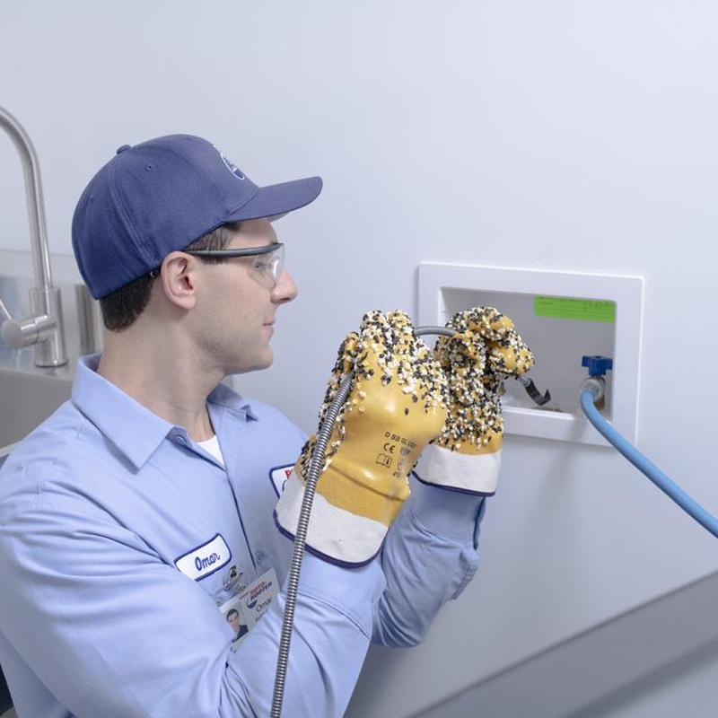 Washer drain pipe with clog removal gloves