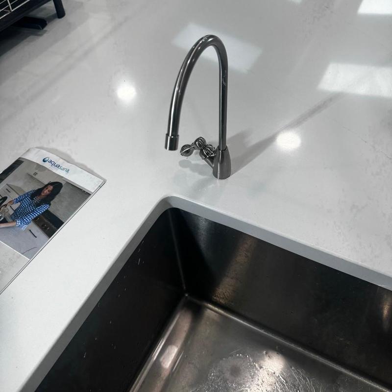 RO system faucet installation in marble countertop near sink