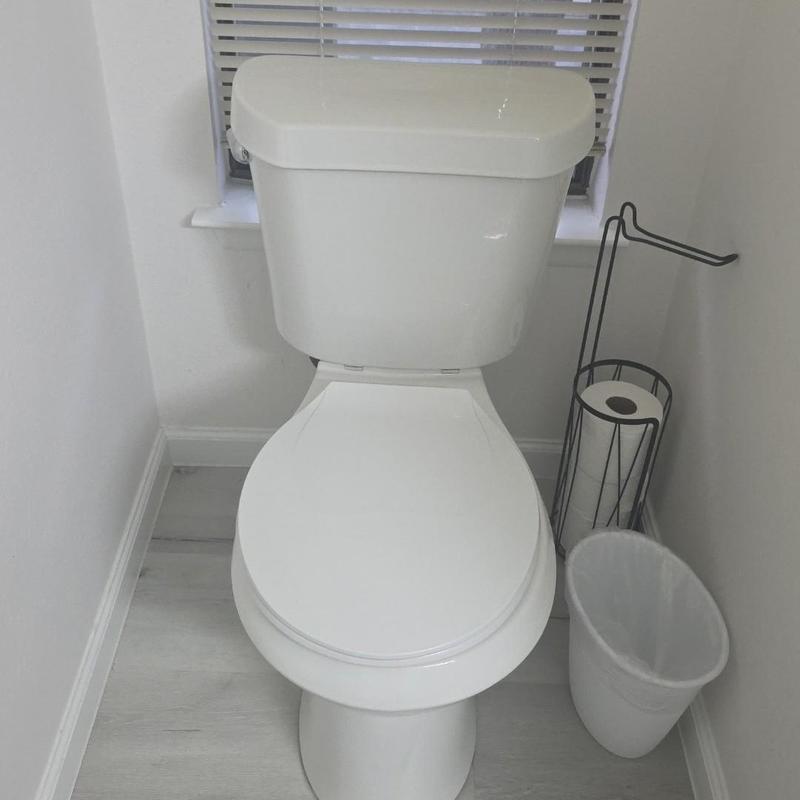 Toilet 88-inch height installation in small bathroom corner