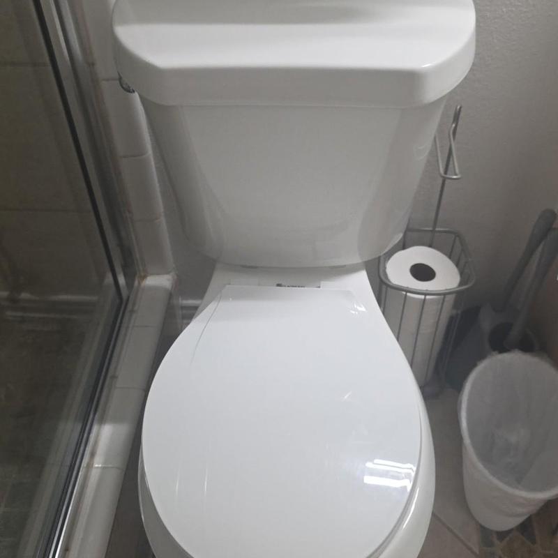White toilet installation in residential bathroom