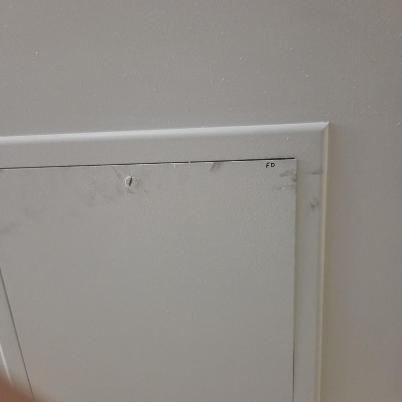 Fire damper access panel in ceiling wall
