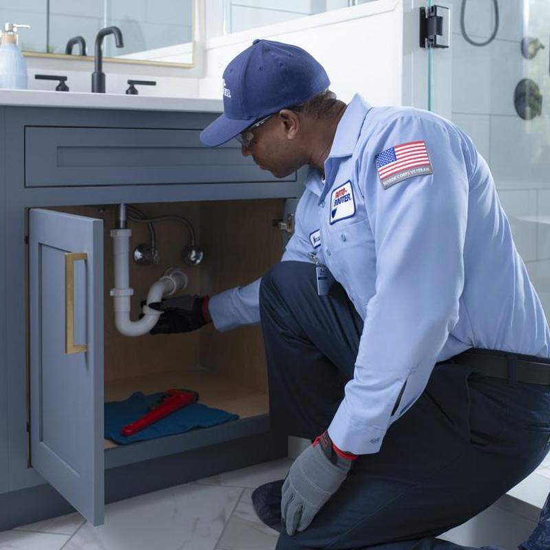 Bathroom sink drain pipe inspection under vanity