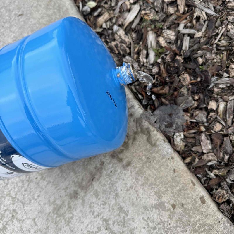 Thermal expansion tank leaking water on concrete floor Thermal expansion tank leaking water on concrete floor