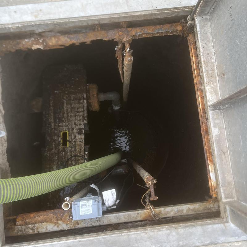 Lift station with rusted broken support rails and hose Lift station with rusted broken support rails and hose