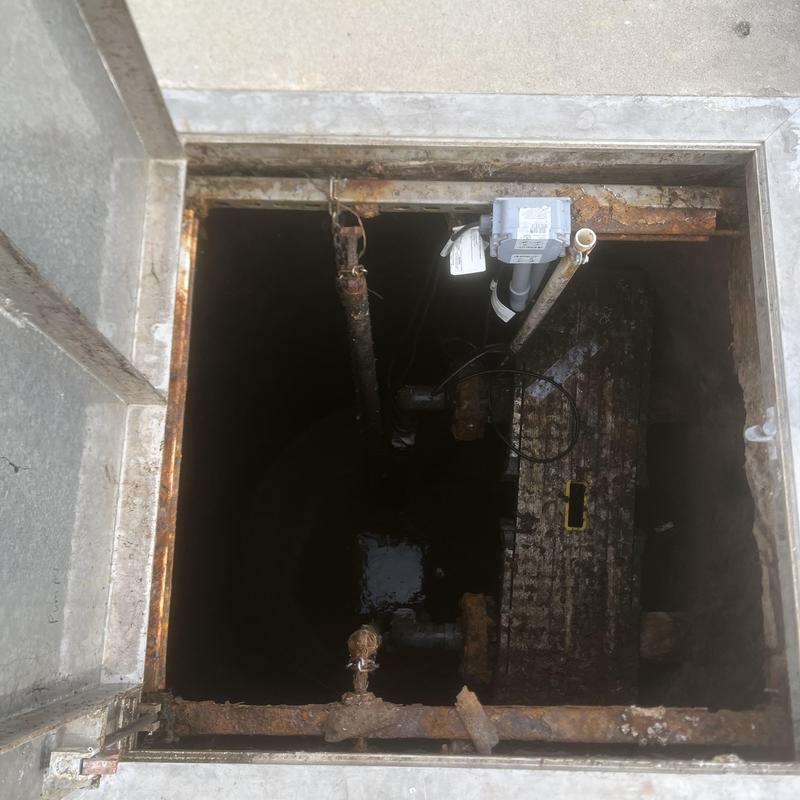 Lift station interior showing rusted support rails Lift station interior showing rusted support rails