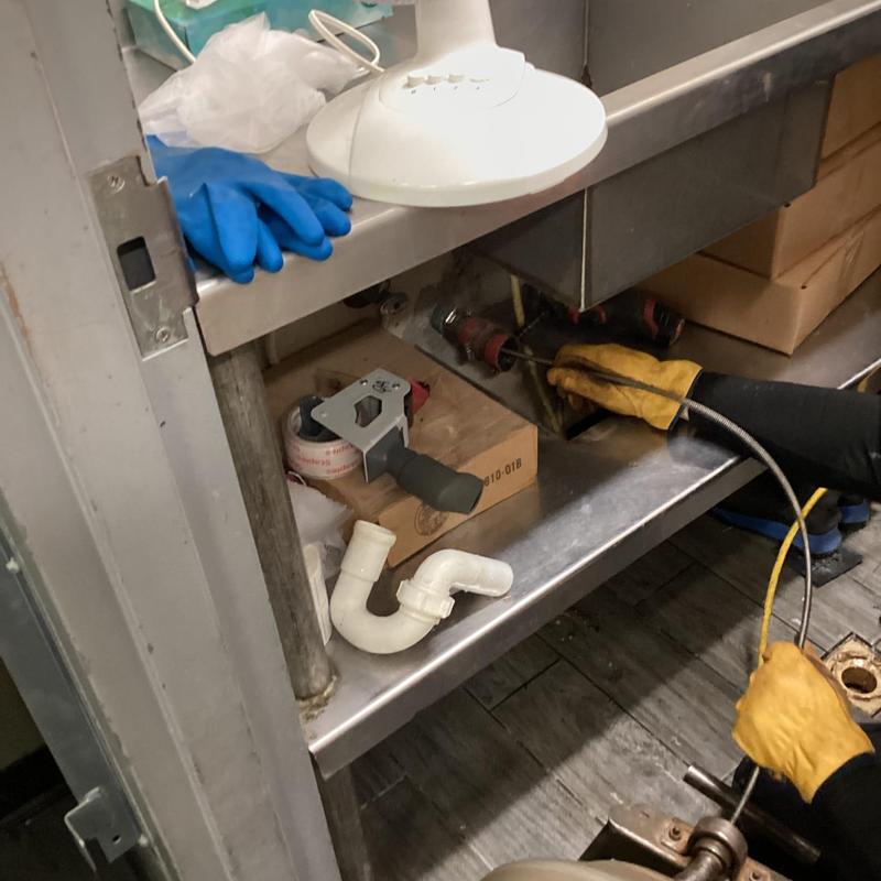 Floor drain cleaning with plumbing snake tool