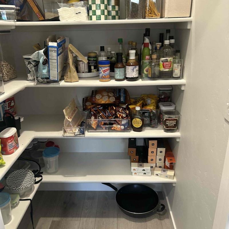 Pantry shelves stocked with food and containers
