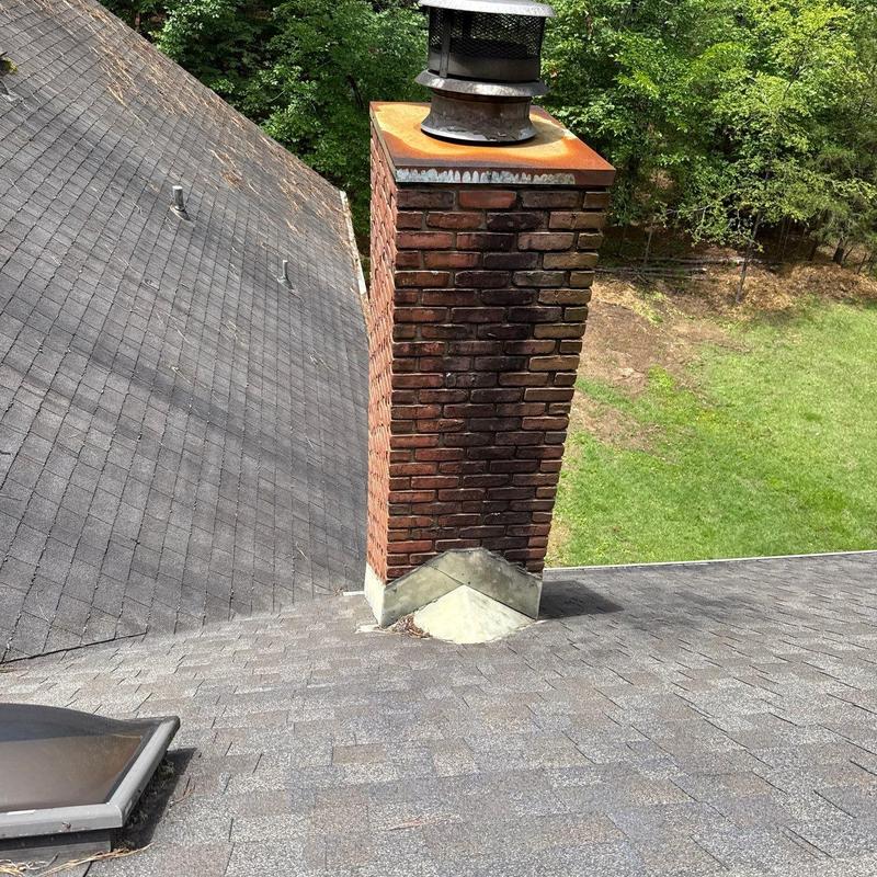 Roof shingles and chimney flashing inspection on pitched roof