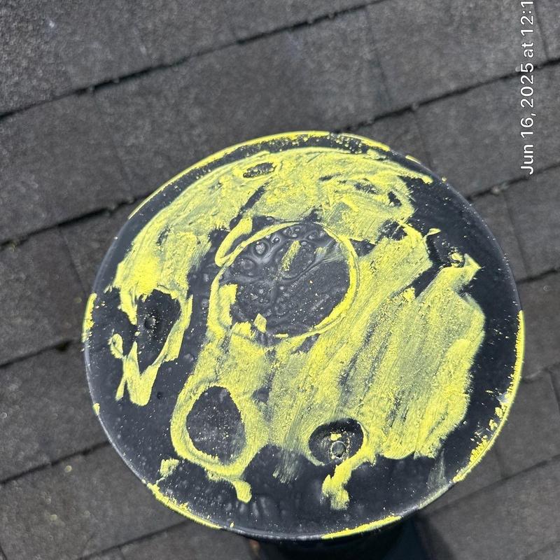 Roof vent top marked with yellow chalk on shingle roof