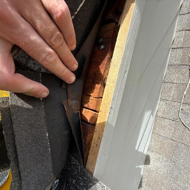 Roof underlayment lifting revealing wood decking and nails