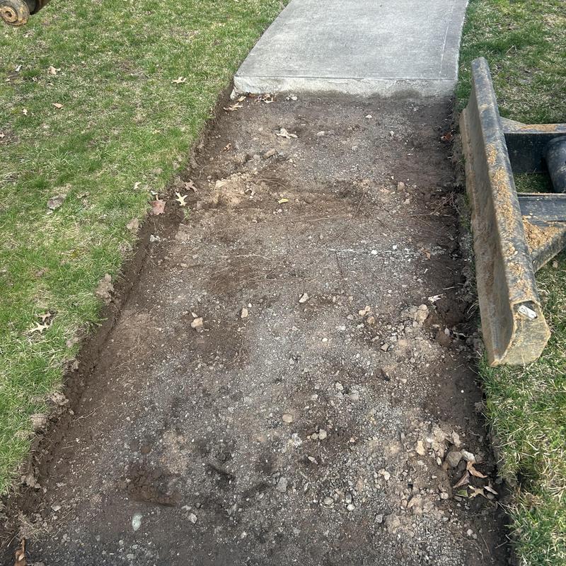 Sewer line excavation site next to concrete sidewalk Sewer line excavation site next to concrete sidewalk