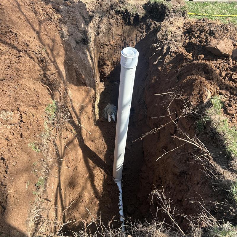 Sewer line pipe installation in dug trench Sewer line pipe installation in dug trench