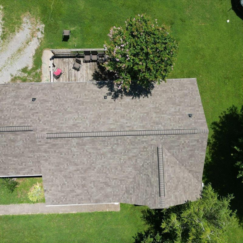 Asphalt shingle roof with ridge vents and patio deck
