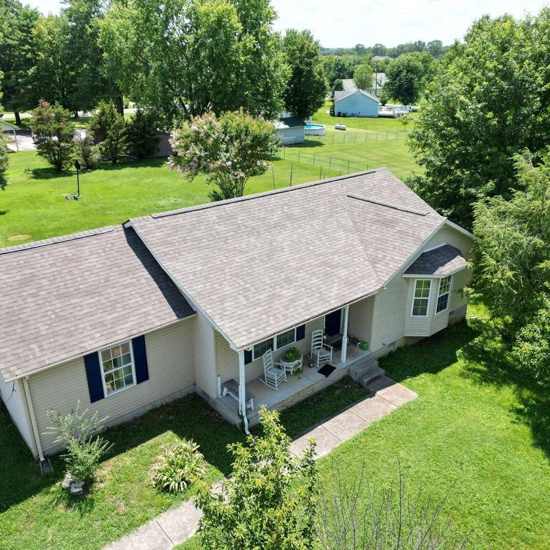 Architectural shingle roof with visible aging and hail damage