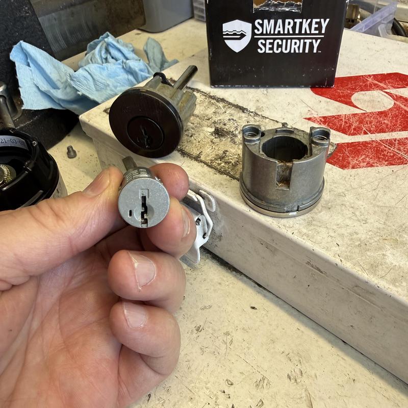 Kwikset lock cylinder rekeying parts on workbench