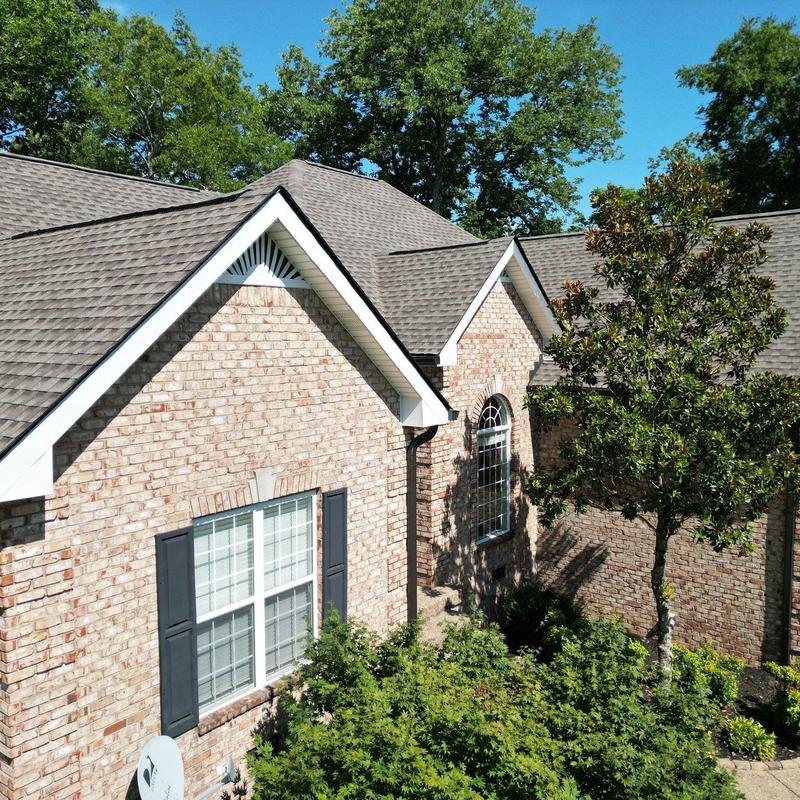 Asphalt shingle roof with hail and wind damage signs