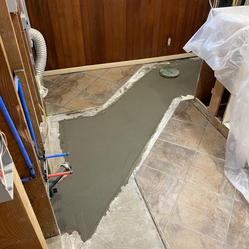 Sewer main concrete floor patching in basement mechanical room Sewer main concrete floor patching in basement mechanical room