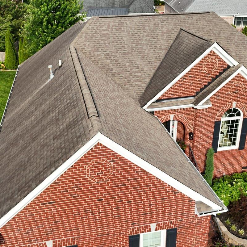 Asphalt shingle roof with ridge vents and gutters
