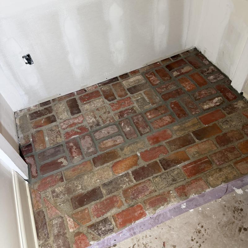 Brick floor with mortar repair in interior corner