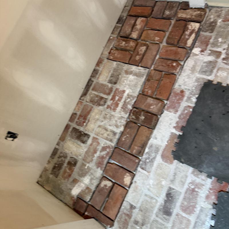 Brick floor section with repaired mortar and bricks