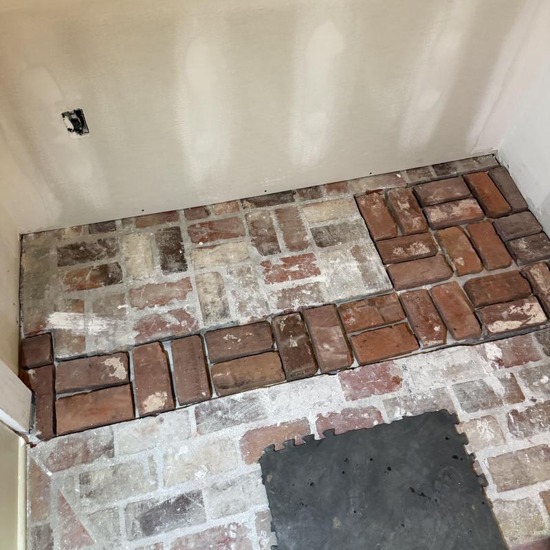 Brick floor with partial replacement in corner area