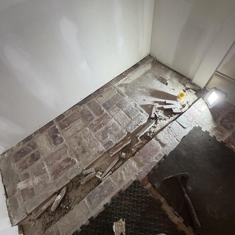 Brick floor with damaged mortar and rubble removal