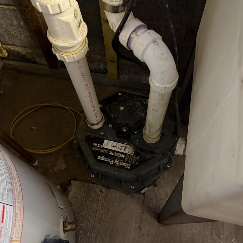 Sump pump with connected PVC piping in basement Sump pump with connected PVC piping in basement