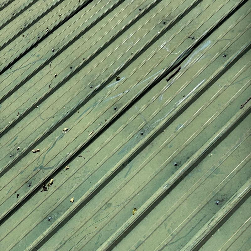 Metal roof panel with damaged and worn areas