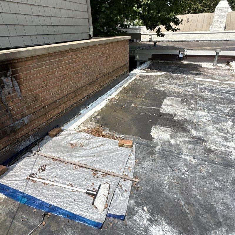 Flat roof surface with hail damage and wear areas