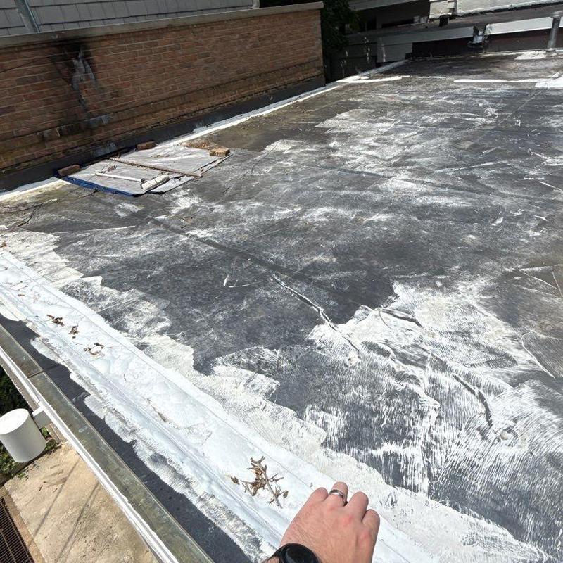Flat roof membrane showing wear and damage