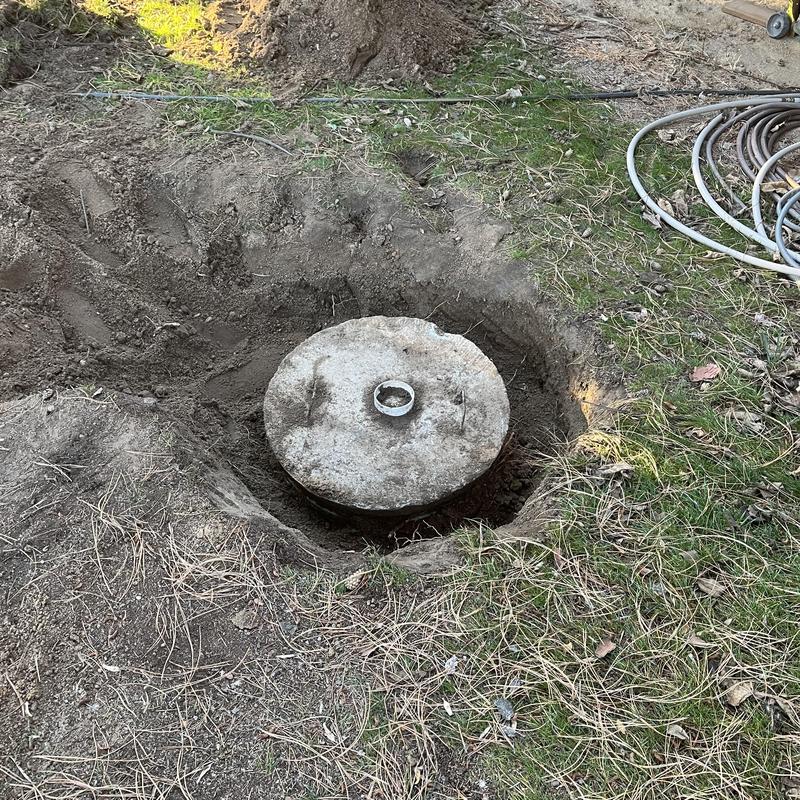 Septic tank partially uncovered with concrete lid