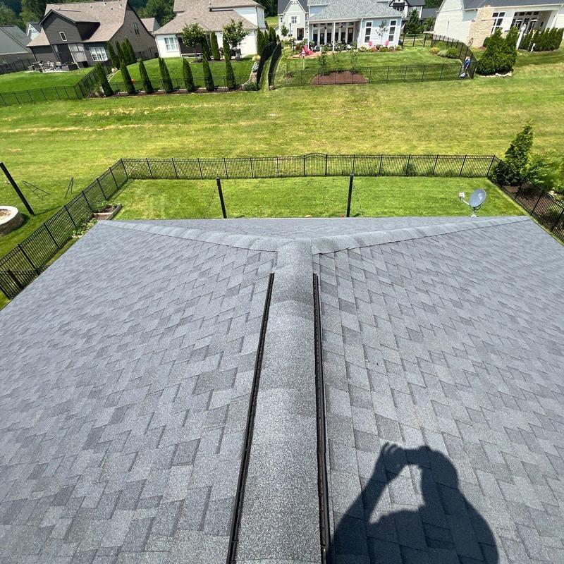 Asphalt shingle roof and ridge caps with hail damage