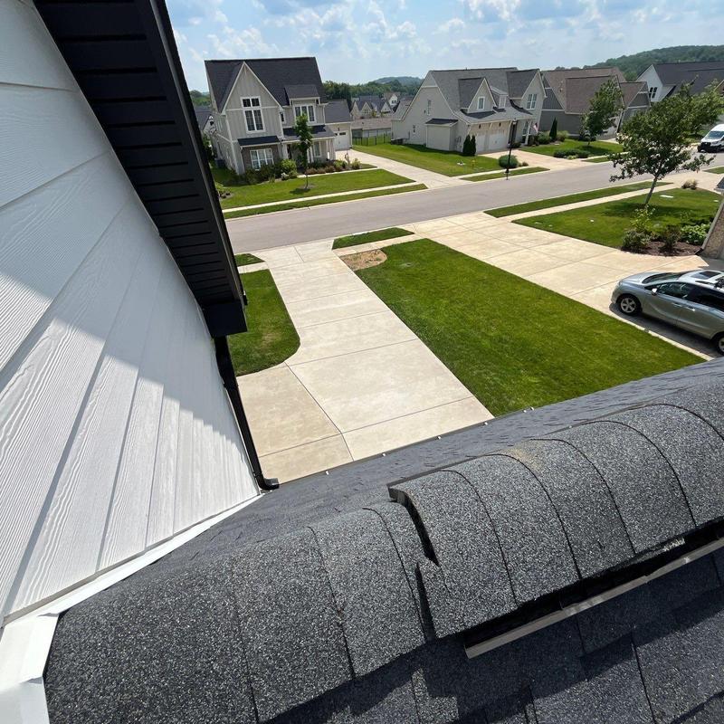 Ridge cap shingles with hail damage on residential roof
