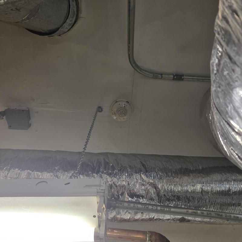 Gas piping with insulated HVAC duct in mechanical room