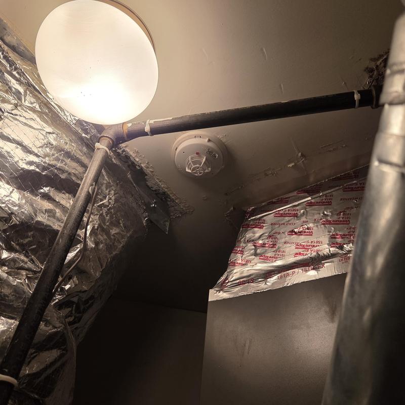 Gas piping near ceiling with smoke detector and insulation