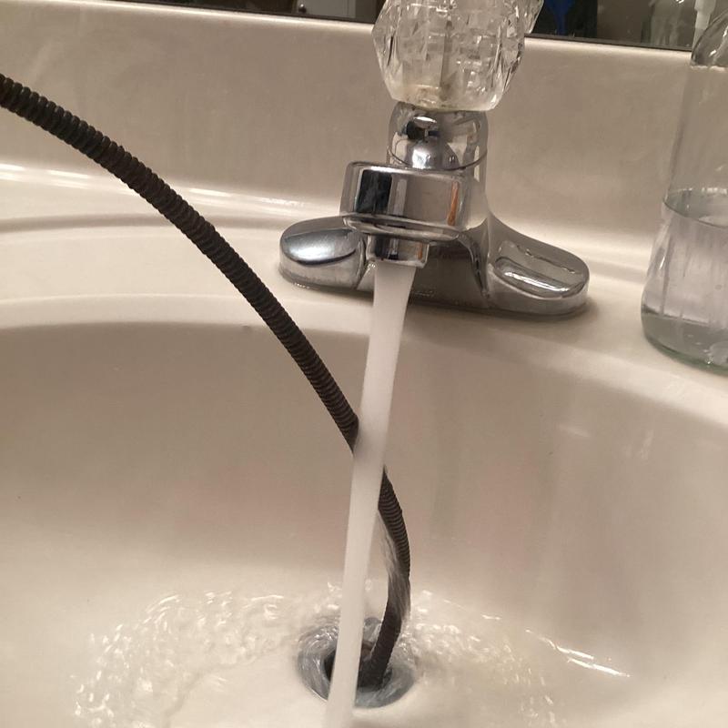 Bathroom sink drain cleaning with cable tool