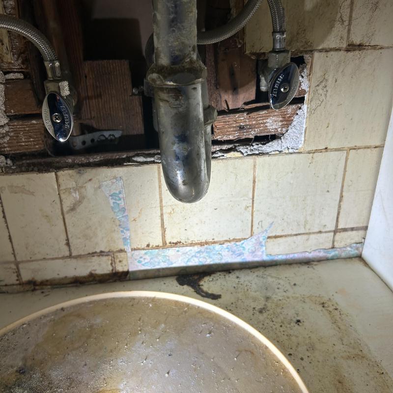 Sink angle stops and old trap plumbing under sink