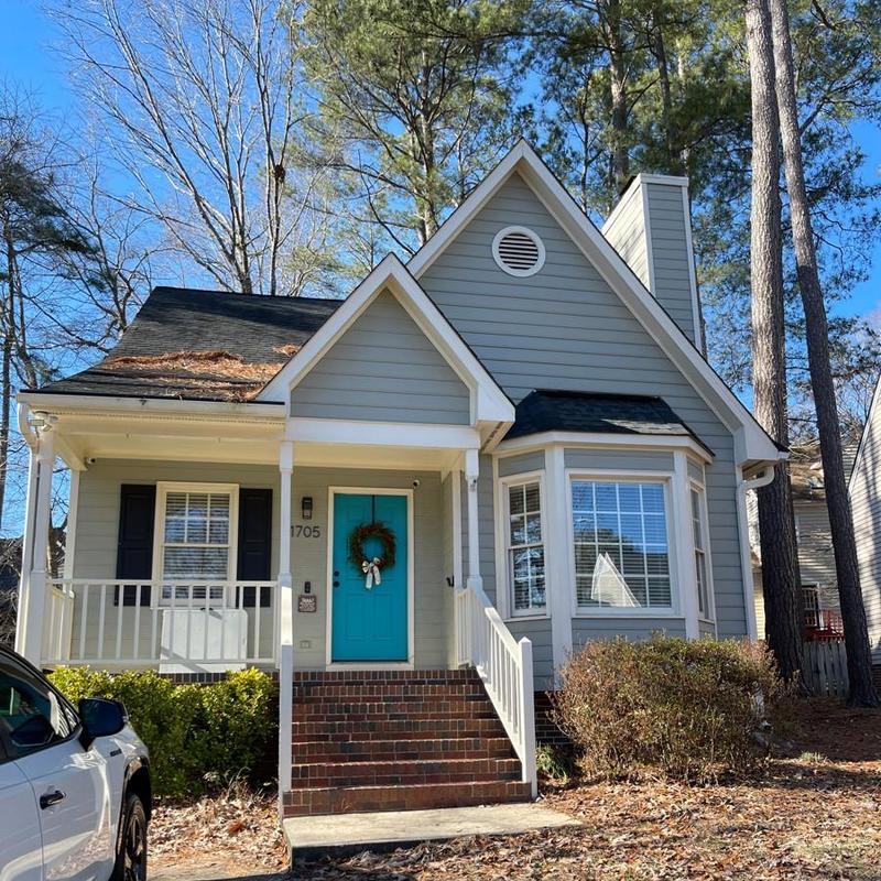 Roof siding and trim on gray home facade