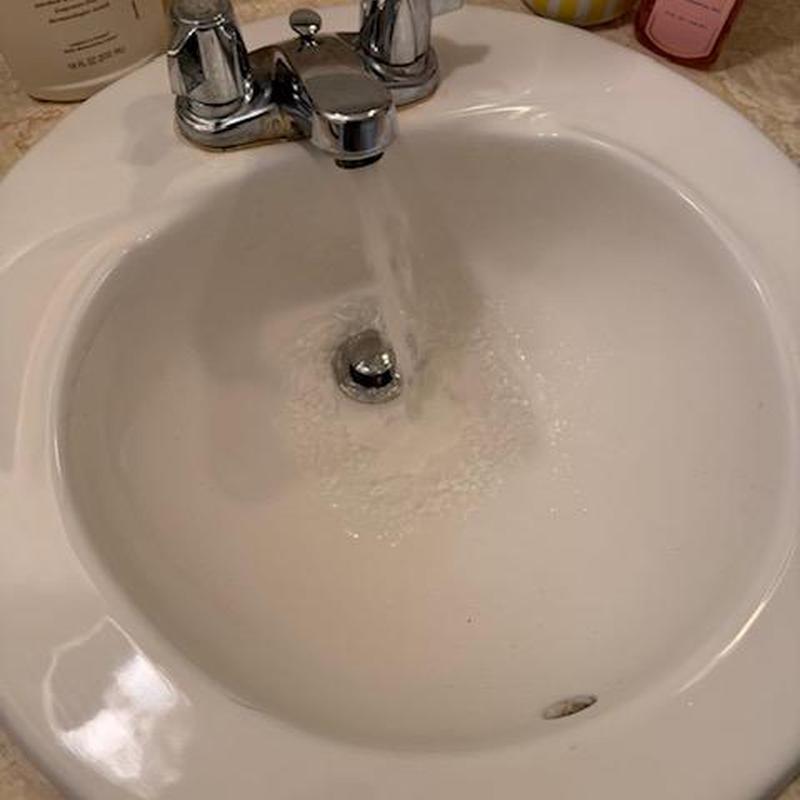 Lavatory drain with running water in sink basin