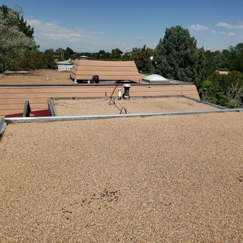 Tar and gravel flat roof with vents and curb